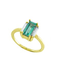 A 18k yellow gold emerald baguette cut ring with side diamonds on a white background.
