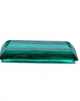 3.13 carat baguette cut Colombian emerald with sparkling bluish-green color.