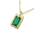 Gold necklace with a natural baguette pendant on a left side position topside view.