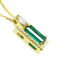 The right-side profile of a yellow gold emerald pendant.
