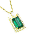 This yellow gold emerald baguette pendant displays the topside on a right side position.