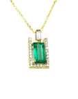 The topside view of a natural emerald baguette cut surrounded of diamonds pendant on a yellow gold chain.