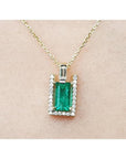 1.14 ct baguette emerald pendant necklace with natural diamonds on a 14K yellow gold chain.