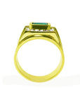 A yellow gold mens colombian emerald ring on a lateral side view.