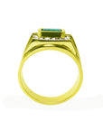 A yellow gold mens colombian emerald ring on a lateral side view.