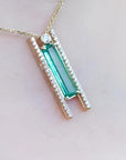 Emerald baguette cut necklace with natural diamonds, 14K yellow gold, and sliding tube bail chain.