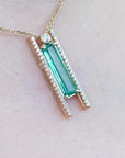 Emerald baguette cut necklace with natural diamonds, 14K yellow gold, and sliding tube bail chain.