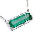 Elongated colombian emerald gemstone necklace encircled in a halo natural diamonds with white gold chain.