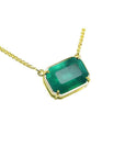Women's Solitaire Emerald necklace sourced from the Muzo mine, set in a handcrafted 18k yellow gold frame