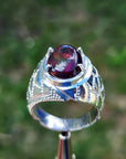 Men's sterling silver ring with a striking black Ethiopian opal gemstone, showing red-orange and blue hues.