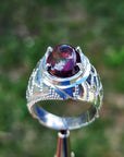 Men's sterling silver ring with a striking black Ethiopian opal gemstone, showing red-orange and blue hues.