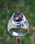 Men's sterling silver ring with a striking black Ethiopian opal gemstone, showing red-orange and blue hues.