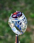 Men's 925 sterling silver ring with a striking black Ethiopian opal, showing red-orange and blue hues.