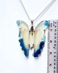 Hand-carved blue agate butterfly pendant with sterling silver frame, shown next to a ruler for size.