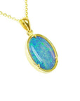 Oval 3.43 ct Australian opal pendant with blue-green sparks, handcrafted in 14K yellow gold.