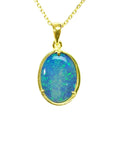 Oval Australian opal pendant with blue-green flashes, set in 14K yellow gold on a delicate chain.