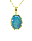 Oval Australian opal pendant with blue-green flashes, set in 14K yellow gold on a delicate chain.