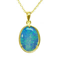 Oval Australian opal pendant with blue-green flashes, set in 14K yellow gold on a delicate chain.