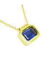 A blue sapphire choker necklace solitaire slider bezel set crafted in 14k yellow gold.