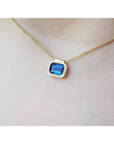 1.01 carat medium-dark blue sapphire choker necklace, bezel set in 14K gold on a cable chain.