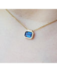 1.01 carat medium-dark blue sapphire choker necklace, bezel set in 14K gold on a cable chain.