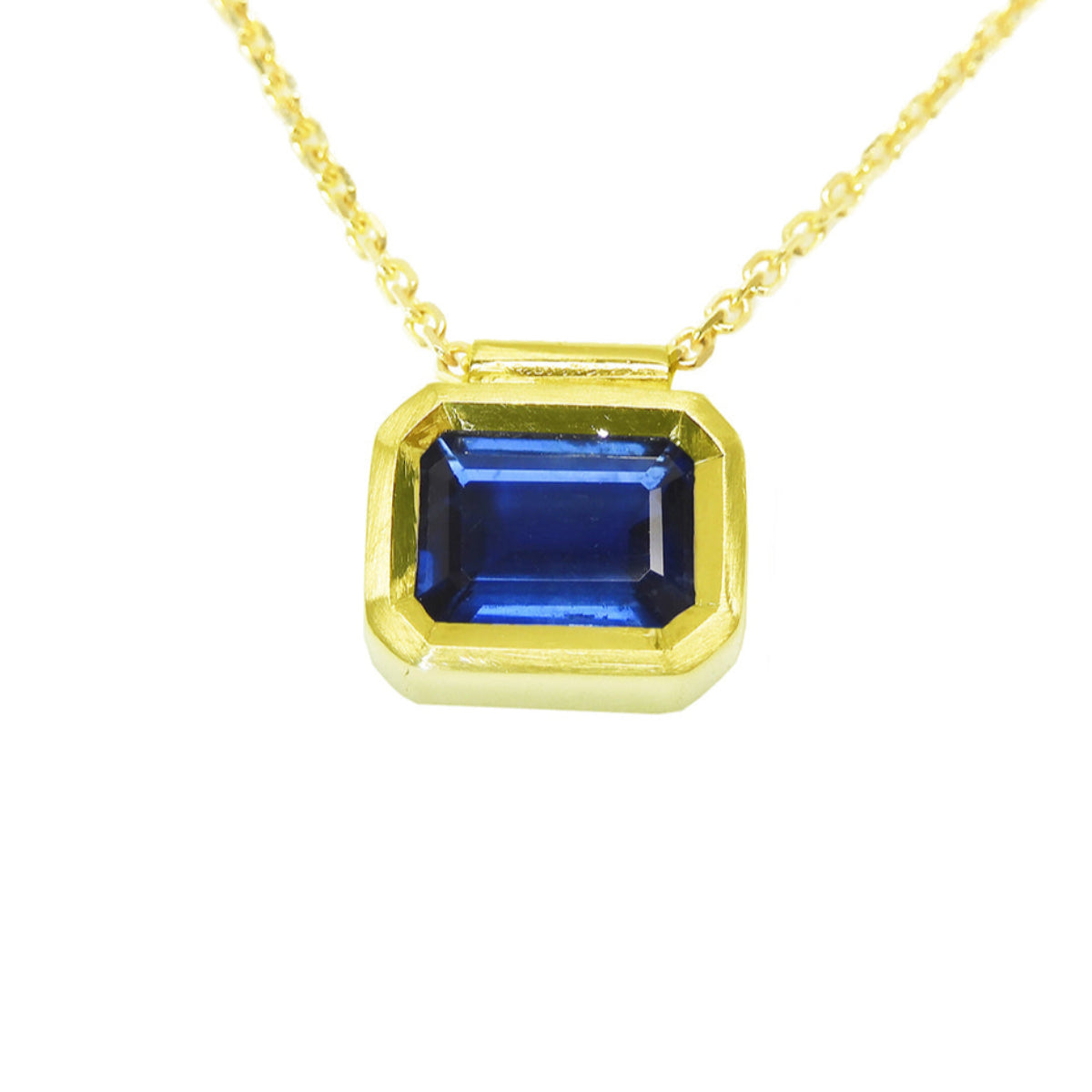 front position and closer view of a blue sapphire choker necklace solitaire bezel set crafted in yellow gold
