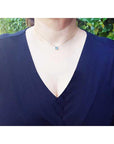 Woman wearing a 1.01 ct blue sapphire bezel-set choker on a 14K gold cable chain.