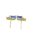 Gold earrings with blue gemstones on a downside view position