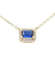 14K yellow gold necklace with an east-west emerald cut blue sapphire surrounded by diamonds.