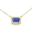 14K yellow gold necklace with an east-west emerald cut blue sapphire surrounded by diamonds.