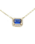 14K yellow gold necklace with an east-west emerald cut blue sapphire surrounded by diamonds.