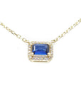 14K yellow gold necklace with an east-west emerald cut blue sapphire surrounded by diamonds.