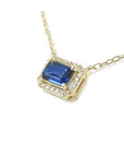 1.03 ct. emerald-cut blue sapphire necklace with diamond halo on a 14K yellow gold chain.