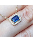 Blue sapphire necklace emerald cut in alo of natural diamonds set in 14k yellow gold.