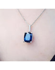 4.11 ct deep blue cushion cut sapphire pendant in 14K white gold on a necklace.