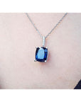 4.11 ct deep blue cushion cut sapphire pendant in 14K white gold on a necklace.