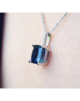 4.11 ct. cushion-cut deep blue sapphire solitaire pendant in 14K white gold on a chain.