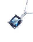 4.11 ct cushion cut deep blue sapphire solitaire pendant in 14K white gold with diamond accents.