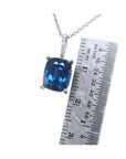 4.11 ct cushion cut deep blue sapphire pendant in 14K white gold with a ruler for scale.
