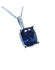 A solitaire blue sapphire necklace featuring a cushion-cut slider pendant with a deep, intense color that flashes beautifully from any angle, set in 14k white gold.