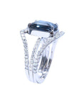 18K white gold ring with a 4.51 ct emerald cut blue sapphire and a three-row diamond band.