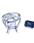 18K white gold diamond ring setting next to a loose 4.51 ct emerald cut blue sapphire.