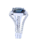 18K white gold ring with a 4.51 ct emerald cut blue sapphire and a three-row diamond band.