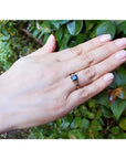 Women's 14K yellow gold ring with a rectangular blue sapphire and tapered diamond accents.