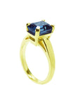 3.13 ct. deep blue emerald-cut sapphire solitaire ring in 14K yellow gold.