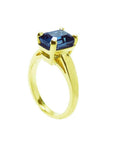 3.13 ct. deep blue emerald-cut sapphire solitaire ring in 14K yellow gold.