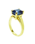 3.13 ct. deep blue emerald-cut sapphire solitaire ring in 14K yellow gold.