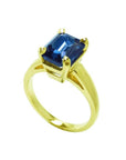 3.13 ct. deep blue emerald cut sapphire solitaire ring in 14K yellow gold.