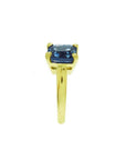 3.13 ct. emerald cut deep blue sapphire solitaire ring in 14K yellow gold.
