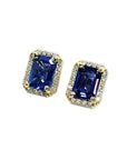 Emerald cut blue sapphire stud earrings with halo diamonds in 14K yellow gold.